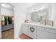 Bathroom with vanity, mirror, and walk-in closet access at 772 Horseman Dr, Port Orange, FL 32127