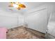 Well-lit bedroom featuring ample closet space and wood-look flooring at 772 Horseman Dr, Port Orange, FL 32127