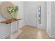 Bright entryway with a wooden console table and a decorative mirror at 772 Horseman Dr, Port Orange, FL 32127