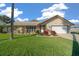 Single-story home with attractive landscaping and a two-car garage at 772 Horseman Dr, Port Orange, FL 32127