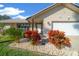 House exterior featuring stone accents and colorful landscaping at 772 Horseman Dr, Port Orange, FL 32127