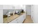 White kitchen cabinets and granite countertops with coffee bar area at 772 Horseman Dr, Port Orange, FL 32127