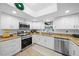 Updated kitchen featuring stainless steel appliances and granite at 772 Horseman Dr, Port Orange, FL 32127