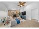 Living room with stone fireplace, ceiling fan and access to a hallway at 772 Horseman Dr, Port Orange, FL 32127