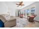 Comfortable living room featuring a beige couch and wicker armchairs at 772 Horseman Dr, Port Orange, FL 32127