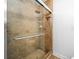 Updated shower with neutral tile and a frameless glass enclosure at 772 Horseman Dr, Port Orange, FL 32127