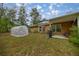 Backyard with greenhouse, shed, and rain barrel at 8465 Sw 202Nd Ter, Dunnellon, FL 34431