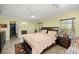 Main bedroom with a king-size bed, walk-in closet and en-suite bathroom at 8465 Sw 202Nd Ter, Dunnellon, FL 34431