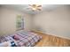 Cozy bedroom featuring a plaid bedspread and a window at 8465 Sw 202Nd Ter, Dunnellon, FL 34431