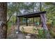 Wooden gazebo with curtains and a hammock at 8465 Sw 202Nd Ter, Dunnellon, FL 34431