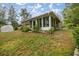 Ranch-style home with sunroom and surrounding garden at 8465 Sw 202Nd Ter, Dunnellon, FL 34431