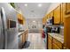 Galley kitchen with wood cabinets, granite countertops, and a breakfast nook at 8465 Sw 202Nd Ter, Dunnellon, FL 34431