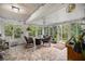 Bright sunroom with tile flooring, wicker furniture, and fireplace at 8465 Sw 202Nd Ter, Dunnellon, FL 34431