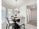 Bright dining area with glass table and four gray chairs at 9125 Se 47 Court Rd, Ocala, FL 34480