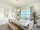 Light and airy dining room with a large wooden table and bench at 9125 Se 47 Court Rd, Ocala, FL 34480