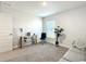 Bright home office features a desk, chair, and comfortable couch at 9125 Se 47 Court Rd, Ocala, FL 34480