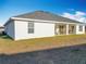 Single story home with gray roof and covered patio at 9125 Se 47 Court Rd, Ocala, FL 34480