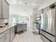 Modern kitchen with gray cabinets, granite counters, and island at 9125 Se 47 Court Rd, Ocala, FL 34480