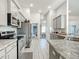 Open kitchen featuring stainless steel appliances and gray cabinets at 9125 Se 47 Court Rd, Ocala, FL 34480