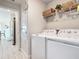 Bright laundry room with washer, dryer, and ample shelving at 9125 Se 47 Court Rd, Ocala, FL 34480
