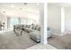 Open concept living room featuring a large sectional sofa and view into the kitchen at 9125 Se 47 Court Rd, Ocala, FL 34480