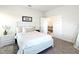Main bedroom with whitewashed headboard and view into living room at 9125 Se 47 Court Rd, Ocala, FL 34480
