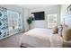 Main bedroom with large TV and floral curtains at 9125 Se 47 Court Rd, Ocala, FL 34480