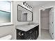 Modern bathroom with granite vanity top, clean fixtures and a large mirror at 963 Nw 65Th St, Ocala, FL 34475