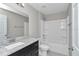 Bathroom with a granite countertop vanity and a shower-tub combo with white tile at 963 Nw 65Th St, Ocala, FL 34475