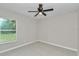 Bright bedroom featuring a ceiling fan and a window with a scenic view at 963 Nw 65Th St, Ocala, FL 34475