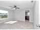 Large bedroom with ceiling fan and en-suite bathroom at 963 Nw 65Th St, Ocala, FL 34475
