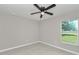 Bright bedroom with a ceiling fan and a window overlooking the outdoors at 963 Nw 65Th St, Ocala, FL 34475