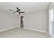 Bright bedroom featuring a ceiling fan, neutral paint, and a view to the bathroom at 963 Nw 65Th St, Ocala, FL 34475