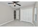 Bedroom with large closet, ceiling fan, and ensuite bathroom entrance at 963 Nw 65Th St, Ocala, FL 34475