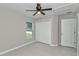 Bedroom featuring a ceiling fan, closet, and a view from the window at 963 Nw 65Th St, Ocala, FL 34475