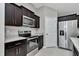 Well-lit kitchen with dark cabinetry, stainless steel appliances, and light countertops at 963 Nw 65Th St, Ocala, FL 34475