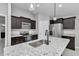 Modern kitchen featuring granite countertops, stainless steel appliances, and dark-wood cabinets at 963 Nw 65Th St, Ocala, FL 34475