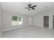 Bright living room featuring tile floors, a modern ceiling fan, and a large window offering ample natural light at 963 Nw 65Th St, Ocala, FL 34475