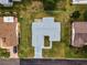 An aerial view shows the layout of this single-Gathering home with a spacious, fenced yard and a long driveway at 9802 Se 178Th Ln, Summerfield, FL 34491