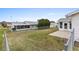A wide view of a expansive backyard with a well-maintained lawn and chain link fence at 9802 Se 178Th Ln, Summerfield, FL 34491
