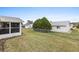 Wide view of a expansive backyard with a well-maintained lawn and chain link fence at 9802 Se 178Th Ln, Summerfield, FL 34491