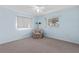 Bright bedroom with light blue walls, carpet flooring, and a ceiling fan at 9802 Se 178Th Ln, Summerfield, FL 34491