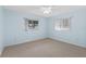 Simple bedroom with ceiling fan and window at 9802 Se 178Th Ln, Summerfield, FL 34491