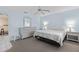 Bright bedroom with king-size bed, dresser, and ceiling fan at 9802 Se 178Th Ln, Summerfield, FL 34491