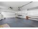 Garage with overhead storage, workbench and ceiling fans at 9802 Se 178Th Ln, Summerfield, FL 34491