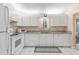 White kitchen with granite countertops and stainless steel appliances at 9802 Se 178Th Ln, Summerfield, FL 34491