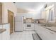 Efficient kitchen, featuring white cabinets and granite countertops at 9802 Se 178Th Ln, Summerfield, FL 34491