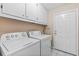 Laundry room with washer, dryer, cabinets, and access door at 9802 Se 178Th Ln, Summerfield, FL 34491