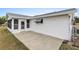 Outdoor patio with white siding, green awning, and screen-enclosed porch is perfect for relaxing outdoors at 9802 Se 178Th Ln, Summerfield, FL 34491