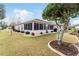 Screened-in patio with a lush backyard and mature trees at 9910 Se 138Th Loop, Summerfield, FL 34491